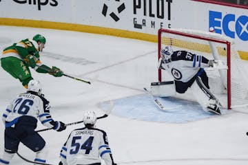 Marcus Foligno of the Wild scored against Jets goalie Connor Hellebuyck on Nov. 23 at Xcel Energy Center.