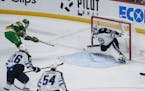  Marcus Foligno (17) scores a goal on Winnipeg Jets goaltender Connor Hellebuyck (37) with a slapshot in the third period. 