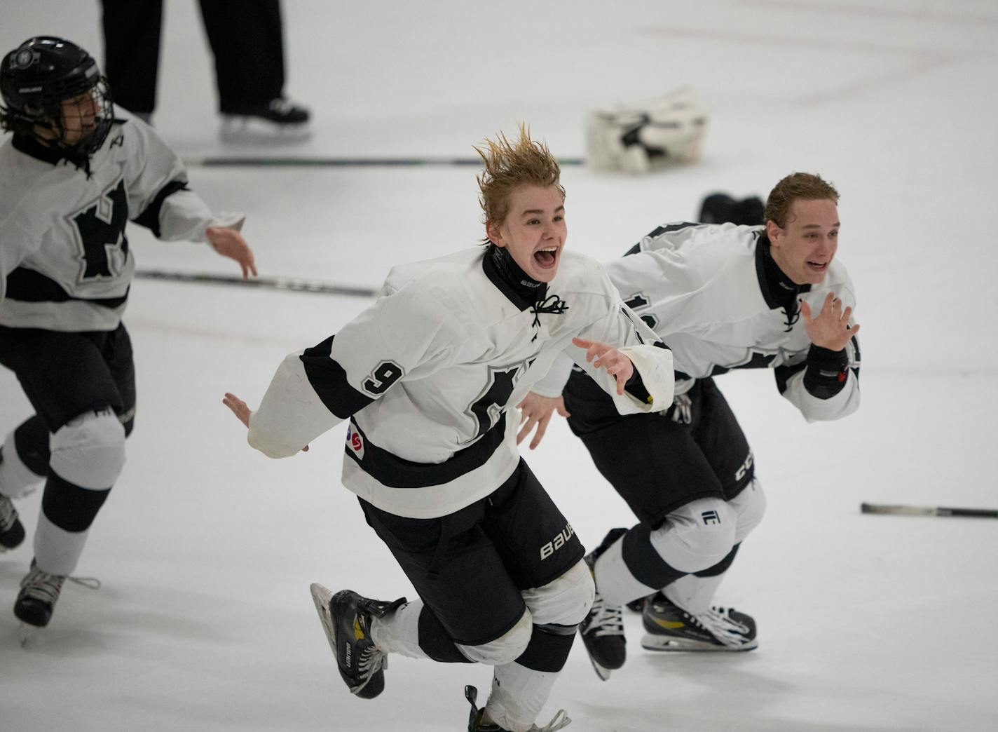 Minneapolis forwards John Bebler (9) and Ben Matthews (12) skated towards the student section to celebrate with their fans after Minneapolis defeating Delano 3 - 1 to win the MSHSL Section 2A Boys Hockey Tournament Championship Wednesday night, March 2, 2022 at the St. Louis Park Rec Center and advance to the State Tournament. ] JEFF WHEELER • Jeff.Wheeler@startribune.com