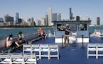 Craig Wenokur, tour guide and vice president of Wendella Sightseeing Co., gives a tour from a boat on Lake Michigan with Chicago in the background on 