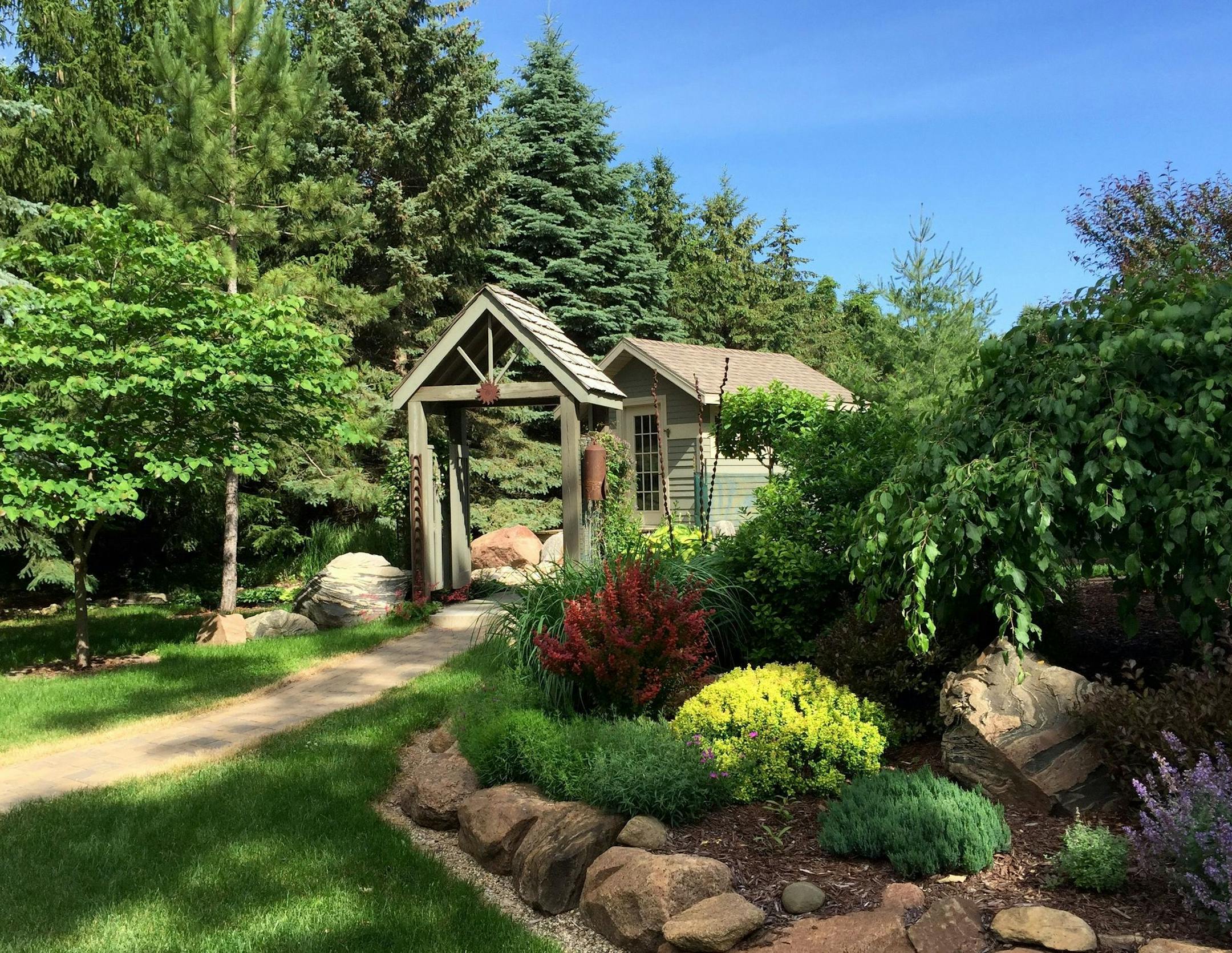 The couple decided to keep their existing trees, shrubs and plants — then rearrange them to complement the new house.
