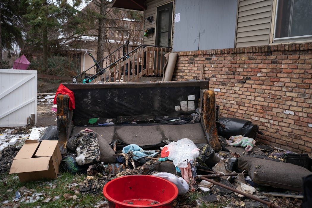 Furniture sat outside the home where a fire broke out in St. Paul on Wednesday, injuring six children and one adult.