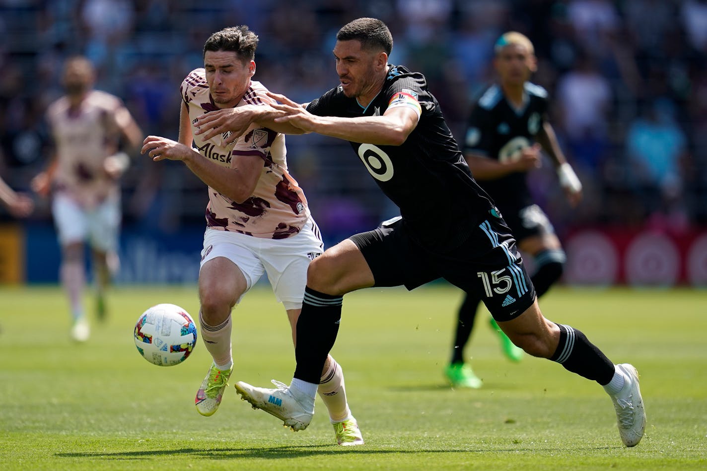 Portland Timbers defender Dario Zuparic (13) and Minnesota United defender Michael Boxall (15) battle for possession during the second half of an MLS soccer match at Allianz Field in Saint Paul, Minn., Saturday, July 30, 2022. (AP Photo/Abbie Parr)