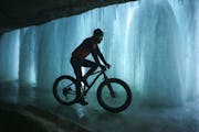 While on his lunch hour, Jesse LaLonde rode a fat tire bike up Minnehaha Creek to get a look at the falls Tuesday afternoon. He works for Twin Six, th