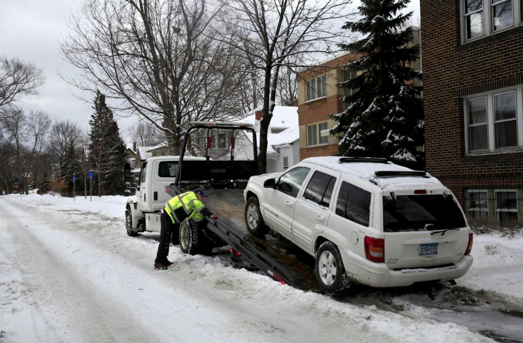 At tow truck hauled away a SUV parked on the even side of 33rd street and Girard Avenue South in Minneapolis, MN on February 10, 2013.