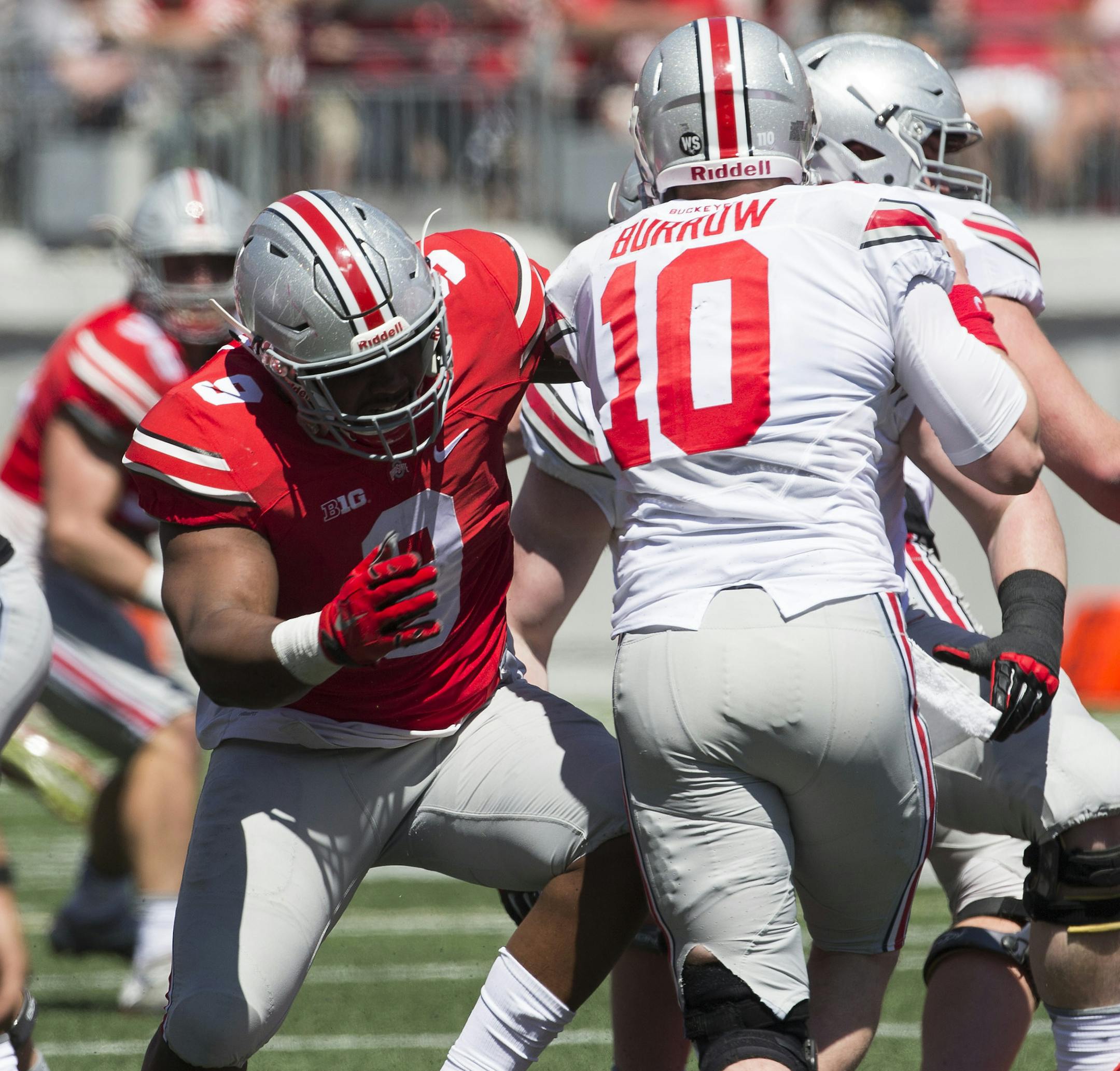 16 April 2016: Ohio State Buckeyes - Scarlet Team Jashon Cornell (9) gets through the line and sacks Ohio State Buckeyes - Gray Team Joe Burrow (10) during the Ohio State Buckeyes Spring Game at Ohio Stadium in Columbus, OH (Photo by: Khris Hale / Icon Sportswire) (Icon Sportswire via AP Images) ORG XMIT: 263449