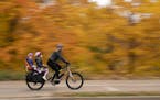 Aimee Witteman on her commuting route home on West River Parkway in Minneapolis with her daughters Barrett, 3, and Georgia, 6, on board her cargo bike