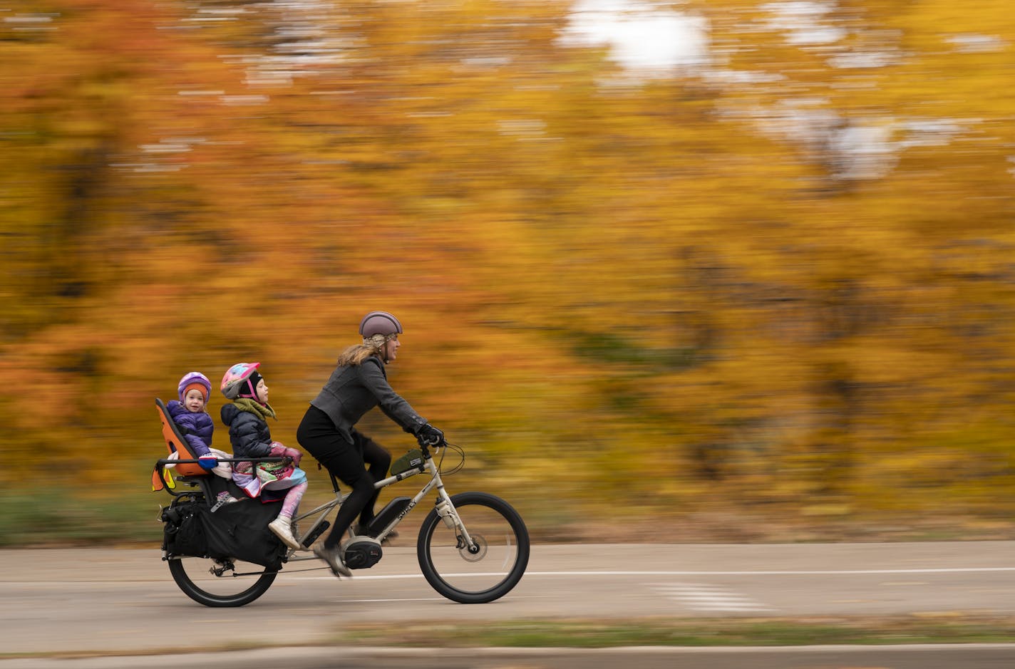 Aimee Witteman on her commuting route home on West River Parkway in Minneapolis with her daughters Barrett, 3, and Georgia, 6, on board her cargo bike.