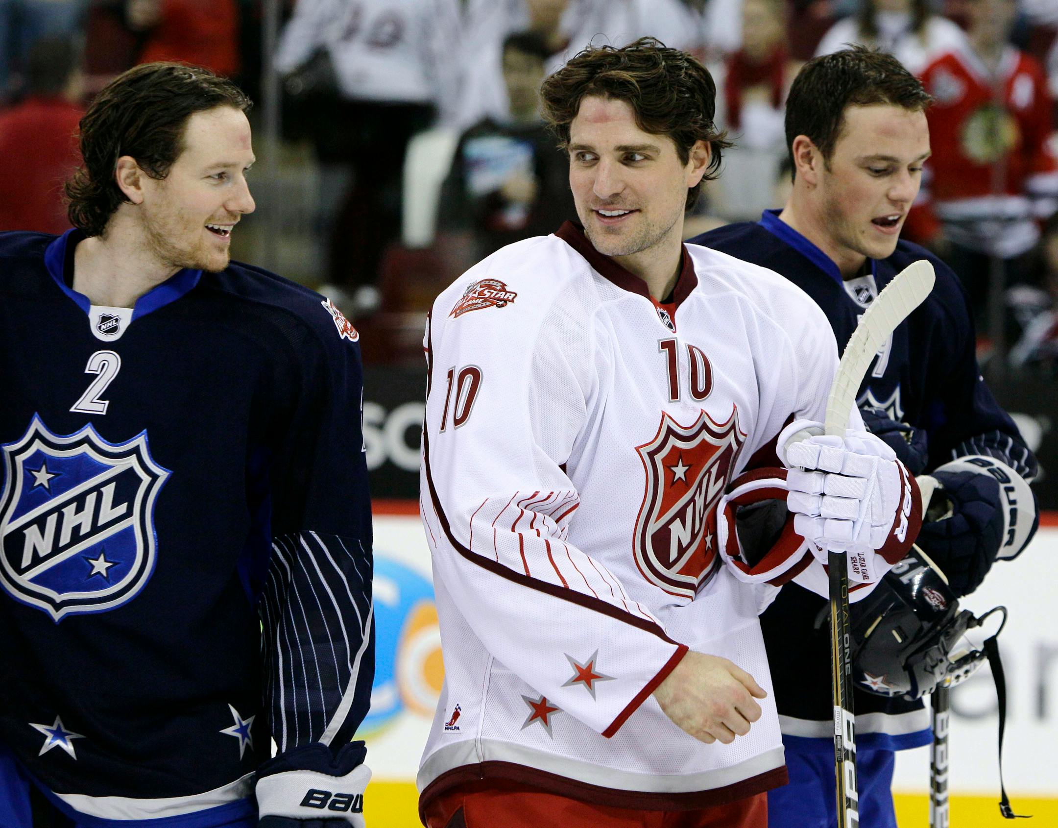 Team Lidstrom's Duncan Keith (2) spoke with Team Staal's Patrick Sharp (10) as Team Lidstrom's Jonathan Toews skated past at the 2011 NHL All-Star Game.