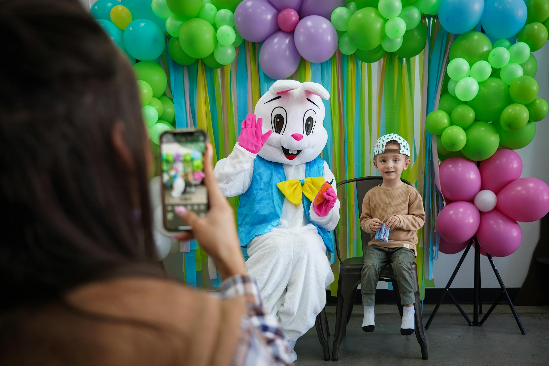 Dustin Jordan, 3, sits alongside the Easter Bunny while his mother Rachel Jordan takes their picture.