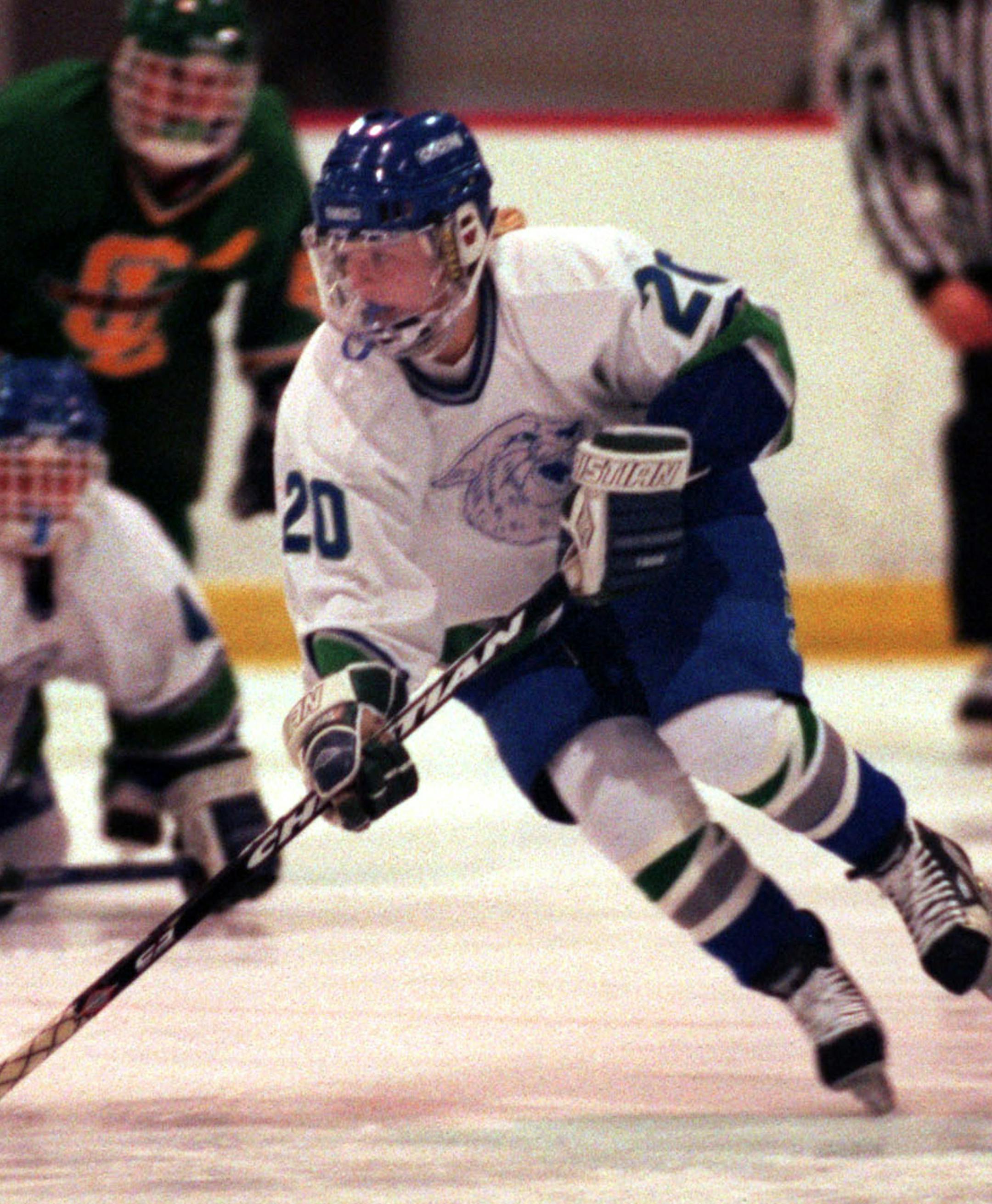 Natalie Darwitz a freshman at Eagan High school pushes the puck up ice during a recent game at the Eagan Civic center arena. ORG XMIT: MIN2014021815345272