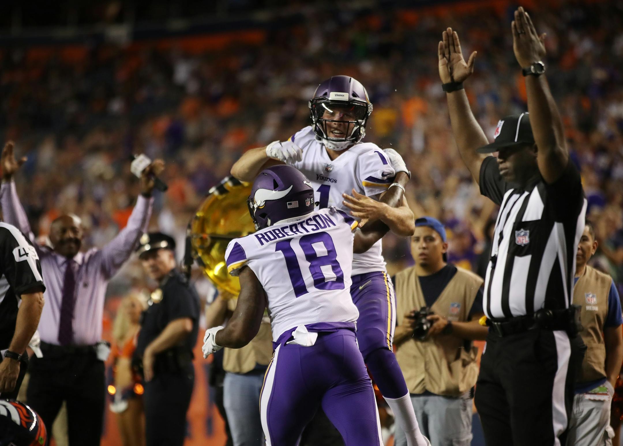 Minnesota Vikings quarterback Kyle Sloter (1) celebrated his forth quarter touchdown run with Korey Robertson (18) Saturday August 11, 2018 at Broncos Stadium at Mile High in Denver, CO.