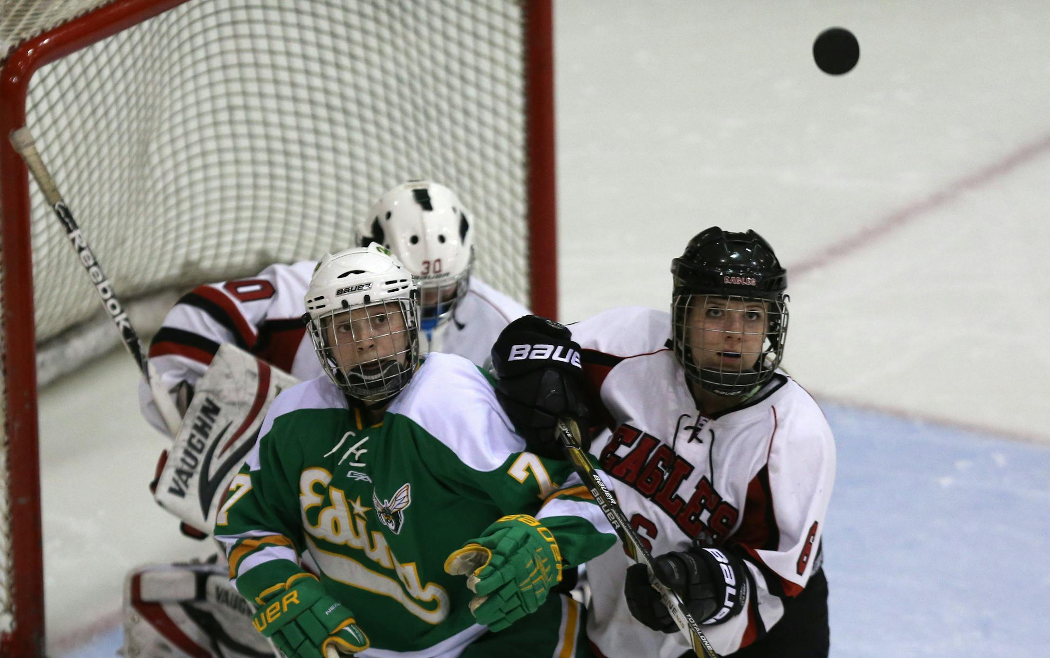 Edina's Taylor Williamson and Eden Prairie's Lauren Boyle watched the puck in the air during the first period in the 2AA Section finals at Ridder Arena in Minneapolis Friday, February 14, 2014. ] (KYNDELL HARKNESS/STAR TRIBUNE) kyndell.harkness@startribune.com