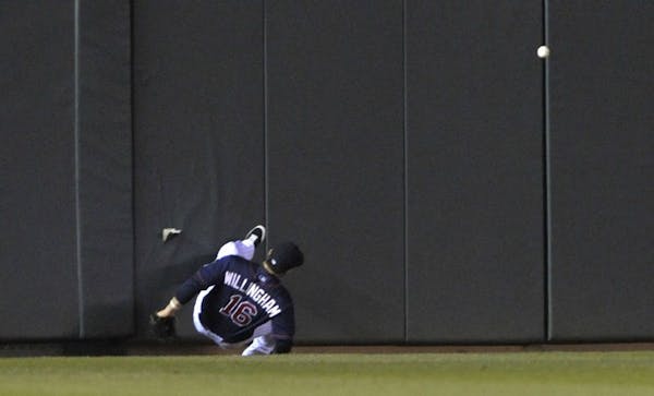 Twins left fielder Josh Willingham crashed into the wall at Target Field, trying to catch what turned into an inside-the-park, three-run home run by t