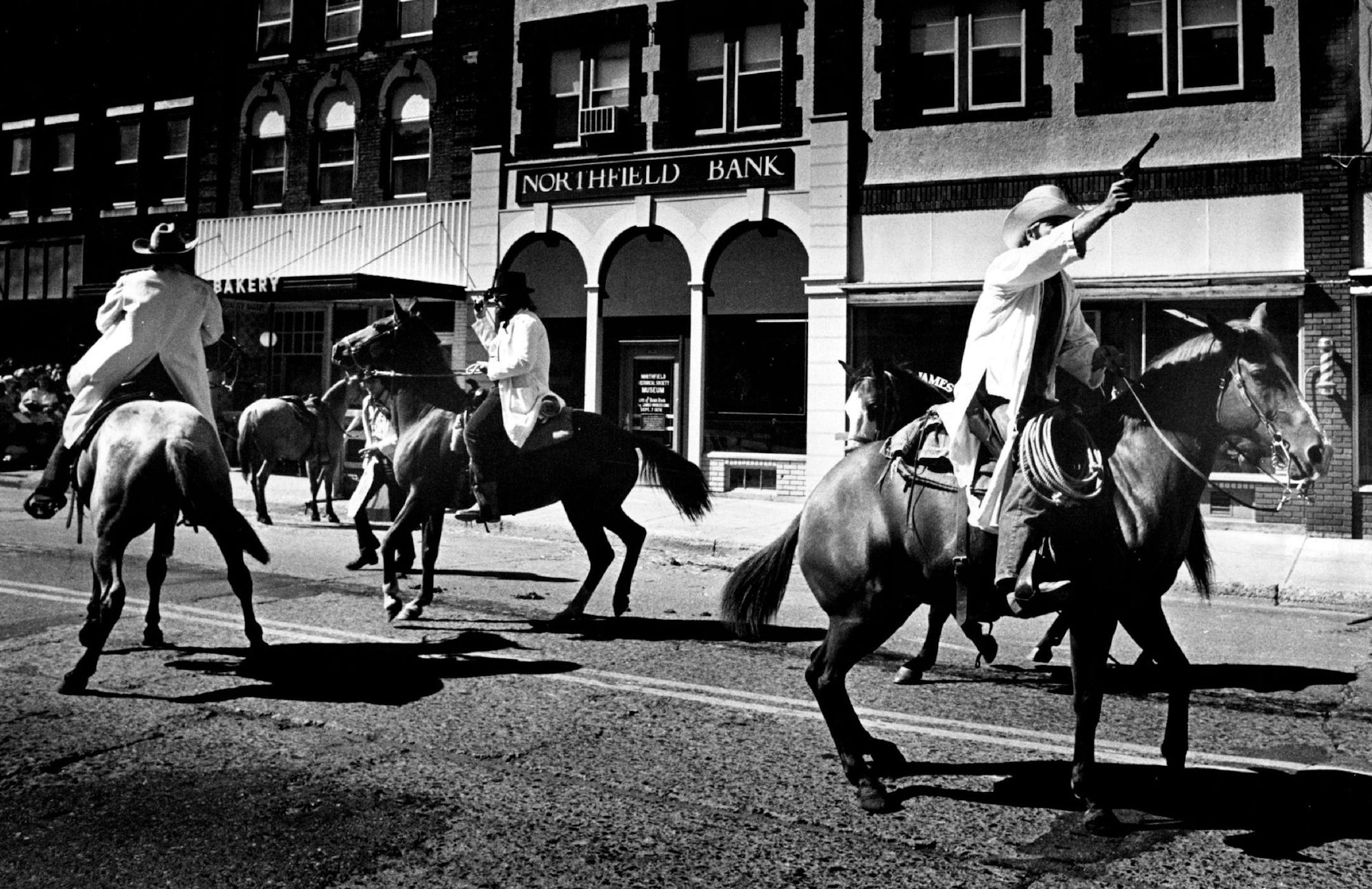 September 13, 1976 A century after the defeat of Jesse James -- Horsemen form the Northfield, Minn., area reenacted the Jesse James gang bank raid Saturday and Sunday during the Defeat of Jesse James Days celebration. Just 100 years ago in September the Missouri gang was foiled by armed citizens as it attempted to rob the First National Bank. During the seven-minute raid two citizens and two gang members were killed. In the background is the original site of the bank, now a museum containing mem