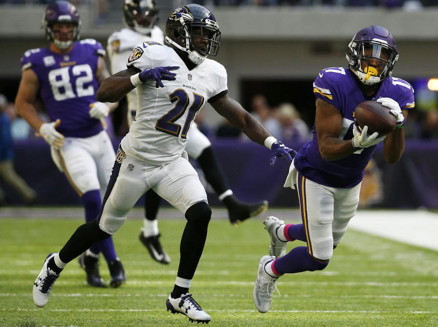 Minnesota Vikings wide receiver Jarius Wright catches a pass ahead of Baltimore Ravens free safety Lardarius Webb (21) during the second half of an NFL football game, Sunday, Oct. 22, 2017, in Minneapolis. (AP Photo/Bruce Kluckhohn)