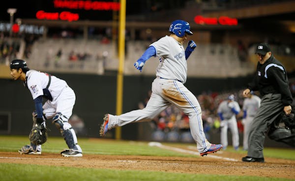 Toronto's Dioner Navarro to scored in the sixth inning against the Twins.