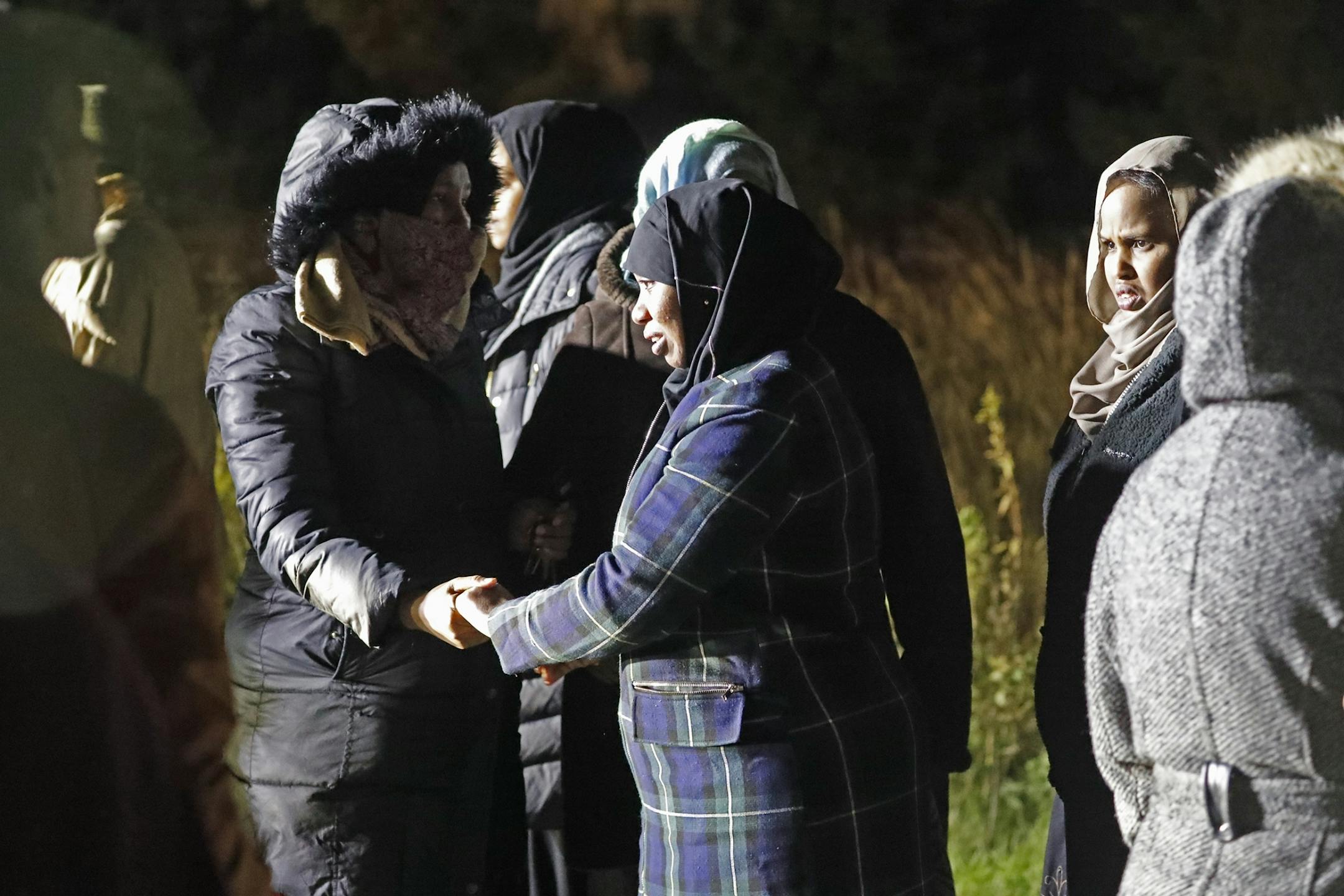 Members of the Somali community grieve at the scene.