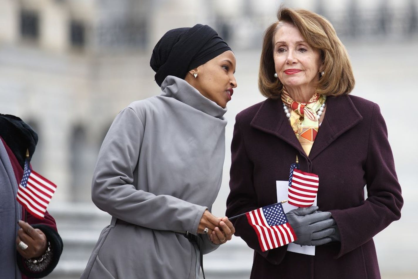 Rep. Ilhan Omar (D-Minn.), left, talks with House Speaker Nancy Pelosi (D-Calif.) during a news conference about the For the People Act, or H.R. 1, outside the U.S. Capitol in Washington, March 8, 2019. The House is scheduled to vote on Friday on the sweeping anticorruption and voting rights bill, which now features a raft of amendments — including implicit rebukes of President Donald Trump.