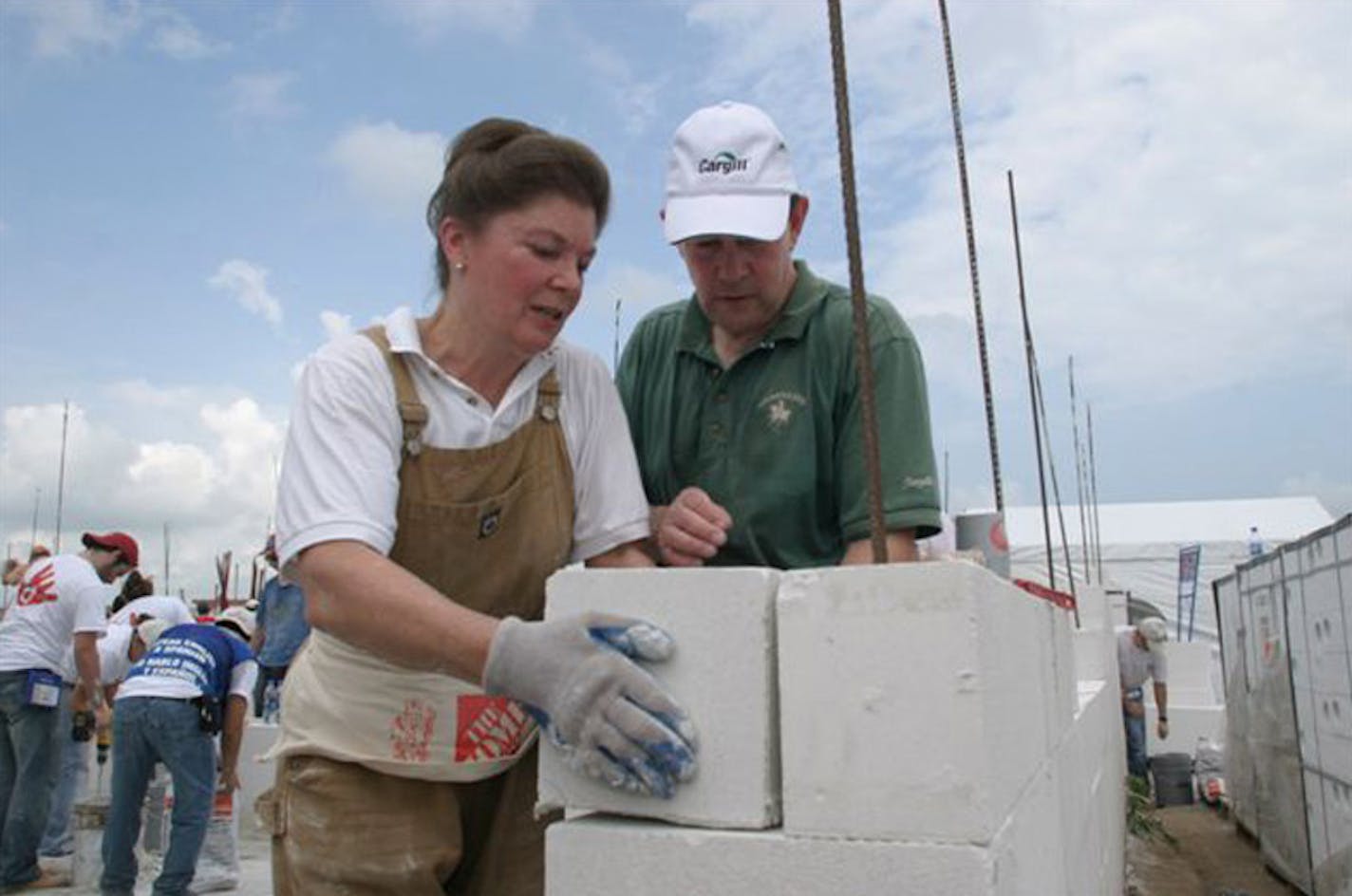 Warren and Mary Lynn Staley laid some block for a Habitat for Humanity house in Mexico. In retirement, the couple has found ways to improve the lives of poor people across the globe.