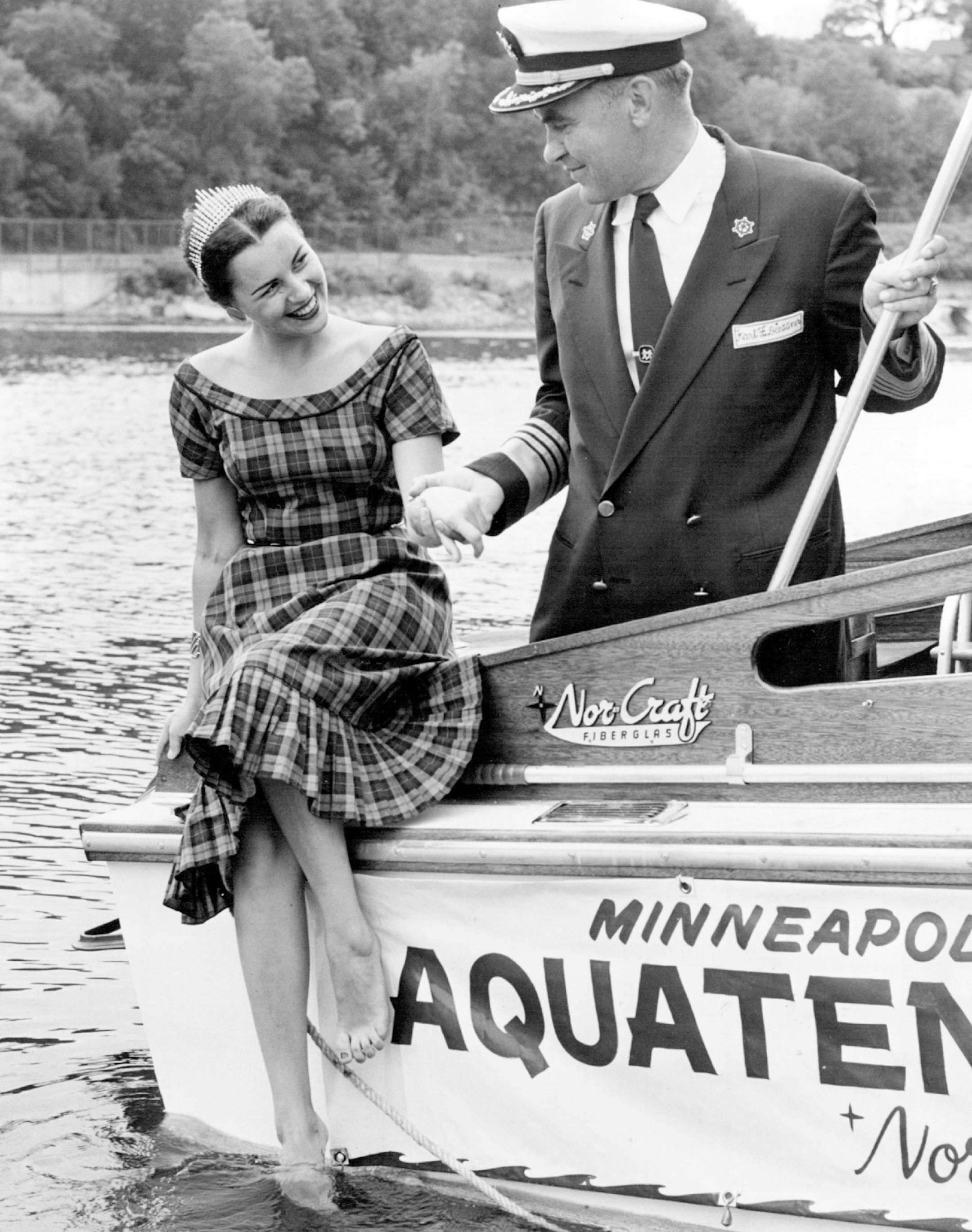 July 5, 1955: Marlene Dolbec (Aqua queen) tries the water as she bids skipper, Clark C. Daily, a Bon Voyage.