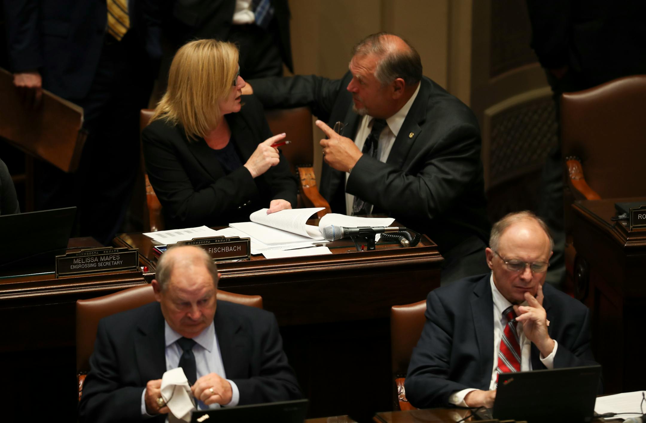 During discussion about the conference committee report on her Omnibus Education Bill, Sen. Michelle Fischbach, R - Paynesville, spoke with Senate Minority Leader Thomas Bakk, DFL - Cook, on the floor of the Senate. Her report was adopted 39 - 28 a short time later.