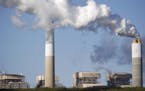 Emissions rise from the coal fired Santee Cooper Cross Generating Station power plant in Pineville, S.C., in March. Construction of new coal plants ar
