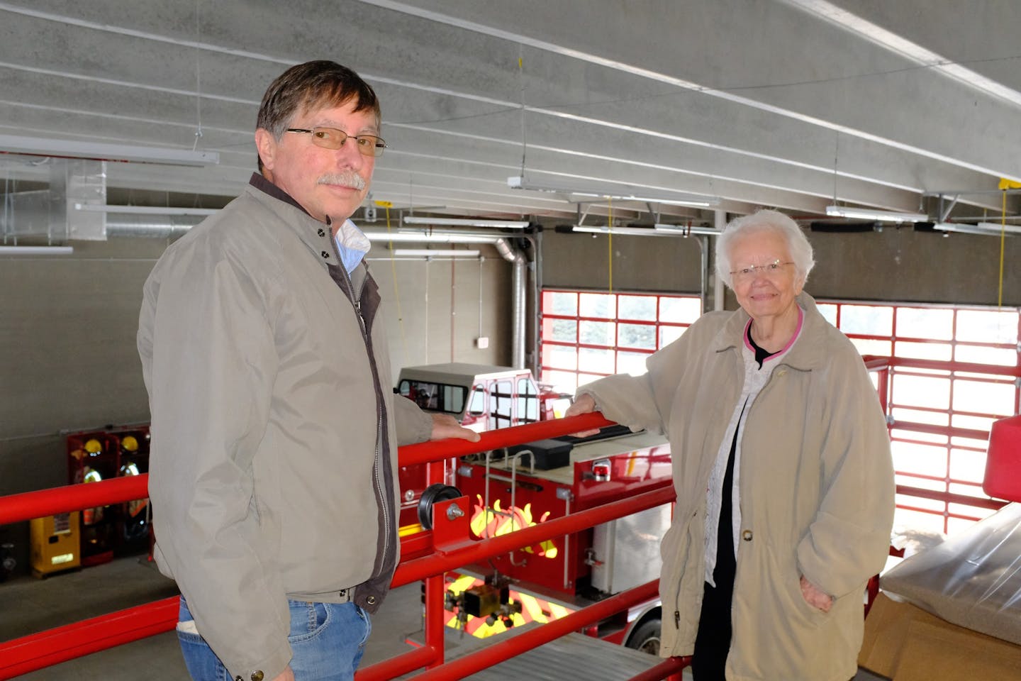 Bruce Hansen, mayor, and Kathy Jensen, city clerk, stand above the parking bays in the new fire station in Clarks Grove, Minnesota. The previous fire station was heavily damaged by a tornado in March 2017. The town of about 700 relied on frugal financial management to afford the new station.