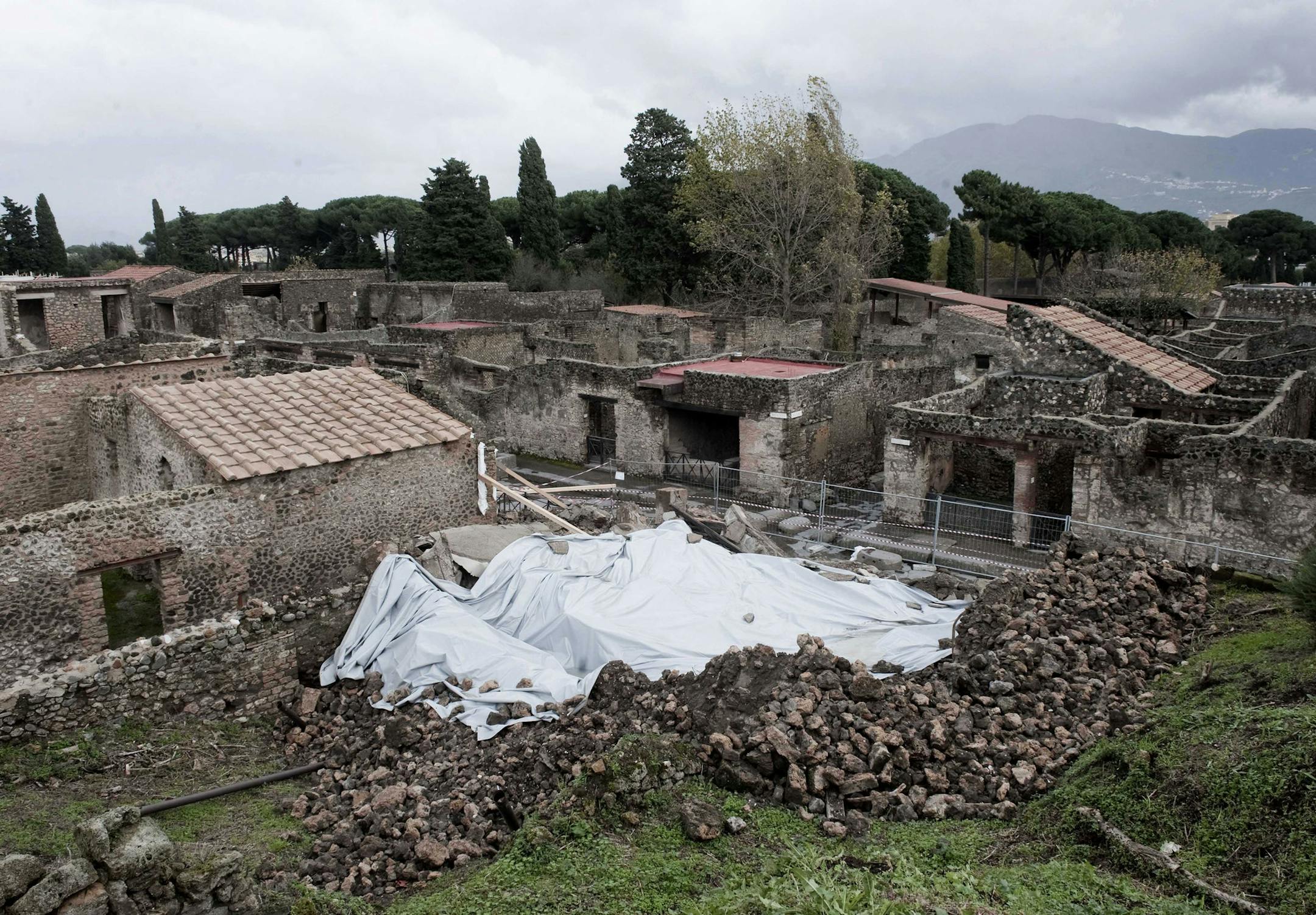 FILE - In this Wednesday, Nov. 10, 2010 file photo, debris of the collapsed house, once used by gladiators to train before combat, is protected from rain in the ancient Roman city of Pompeii, Italy. Anti-Mafia prosecutors say they have ordered an inspection into restoration work at the Pompeii archaeological site to make sure that the organized crime has not infiltrated the project. Prosecutors said in a statement Tuesday that the day-long inspections were carried out on areas being restored as