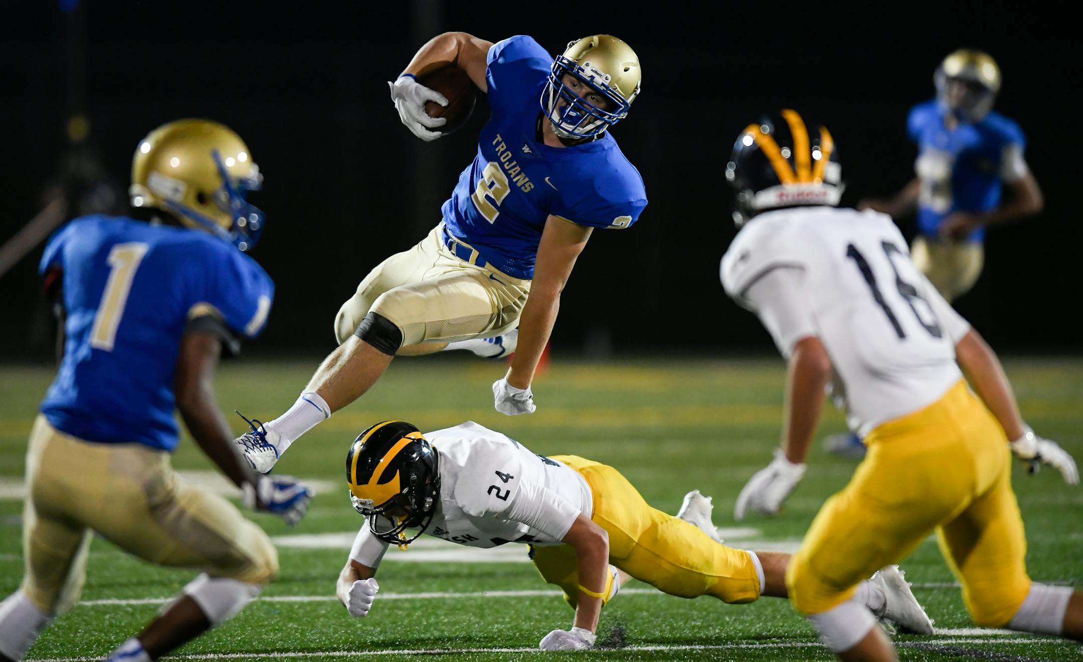 Wayzata tight end Billy Riviere (2) leapt over Rosemount wide receiver Cole Kraemer (24) in the fourth quarter. ] AARON LAVINSKY ï aaron.lavinsky@startribune.com Wayzata played Rosemount in a high school football game on Thursday, August 31, 2017 at Wayzata High School in Plymouth, Minn.