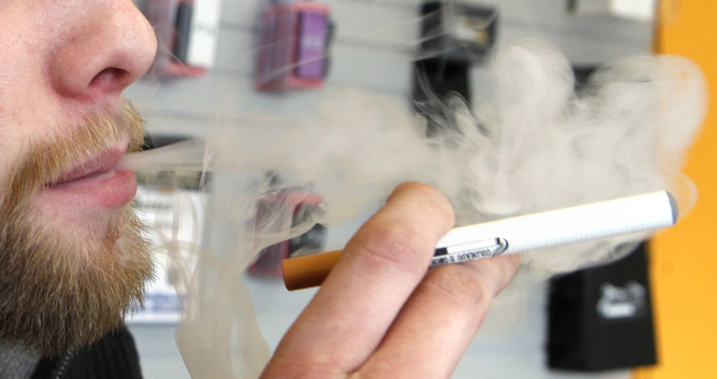 FILE - A sales associate demonstrates the use of a electronic cigarette and the smoke like vapor that comes from it in Aurora, Colo. on Wednesday, March 2, 2011. Children - like adults - are increasingly trying electronic cigarettes, according to the first large national study to gauge use by middle and high school students. About 2 percent of the students said they&#xed;d used an e-cigarette in the previous month, according to a survey done in 2012. That was up from 1 percent in 2011. Results w