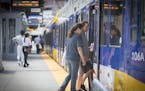 Passengers boarded the the light-rail train at the U.S. Bank Stadium stop last month. Bus and train riders will pay more come October.