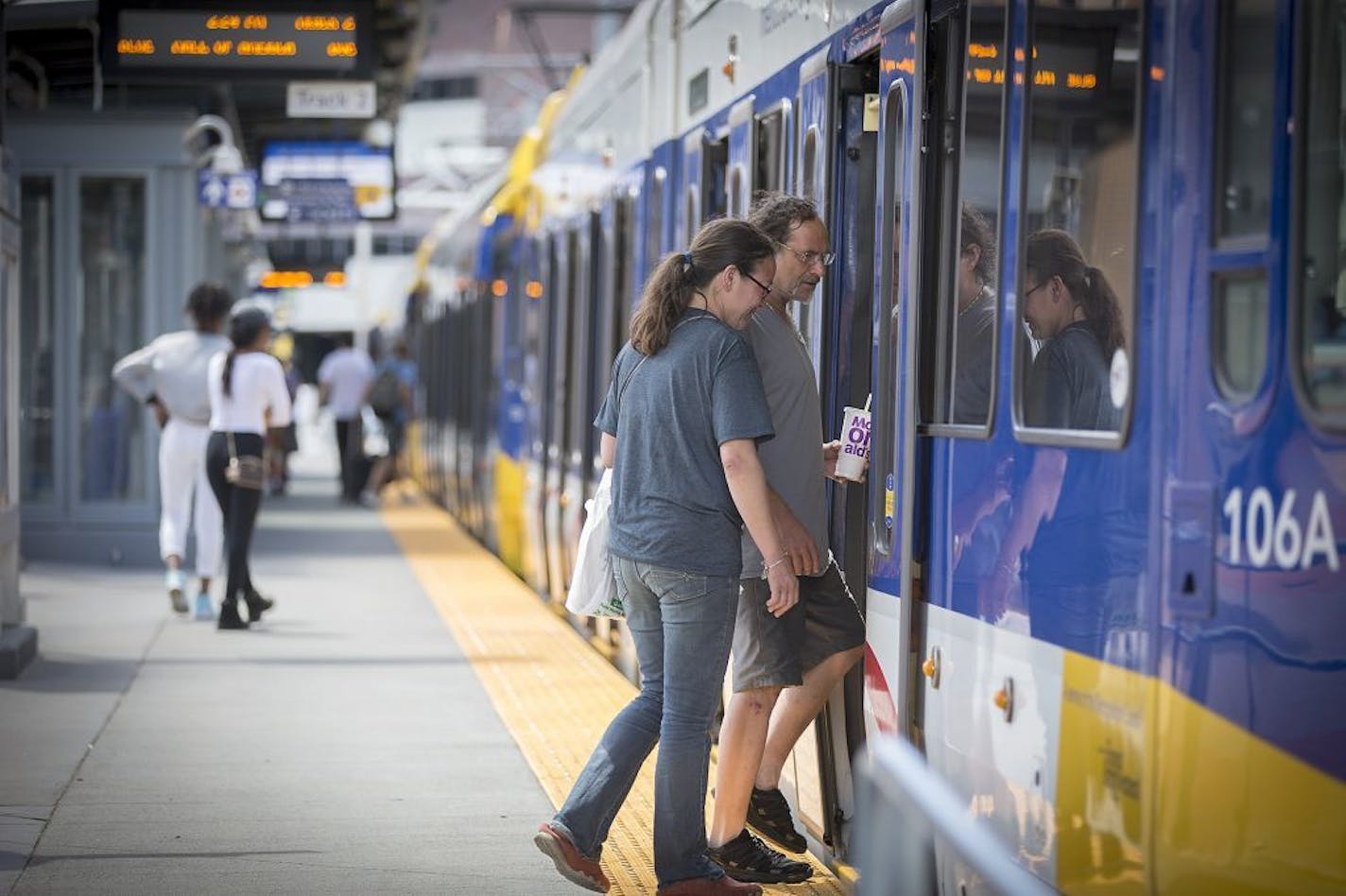 Passengers boarded the the light-rail train at the U.S. Bank Stadium stop last month. Bus and train riders will pay more come October.