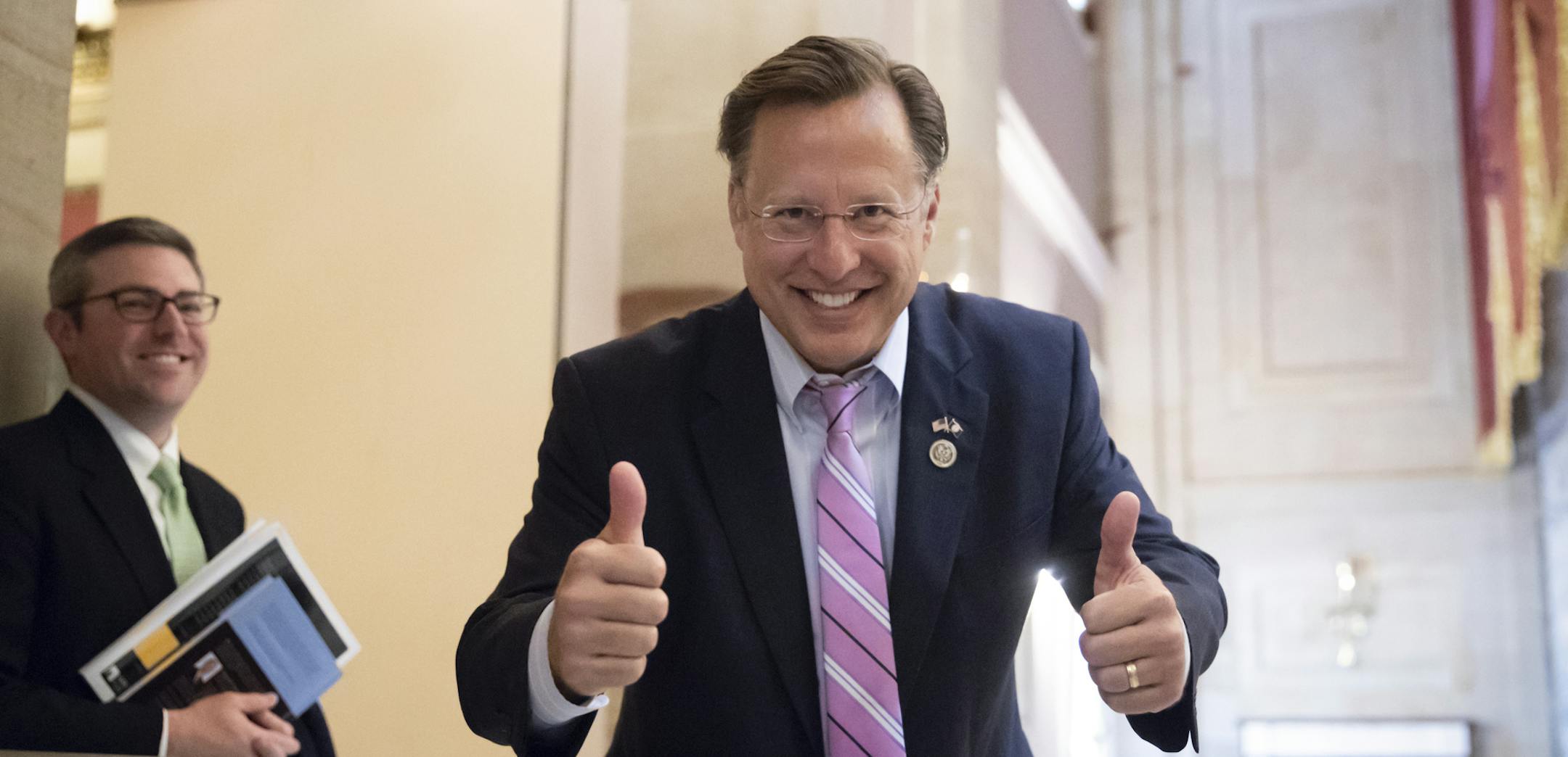 Rep. Dave Brat, R-Va., a member of the conservative House Freedom Caucus, smiles before the vote on the House farm bill which failed to pass, at the Capitol in Washington, Friday, May 18, 2018. The Freedom Caucus opposed the measure, seeking leverage to obtain a vote on a hard-line immigration plan. The vote was a blow to GOP leaders and exposed fissures within the party in the months before the midterm elections, when Republicans are trying to motivate voters to the polls to keep their majority