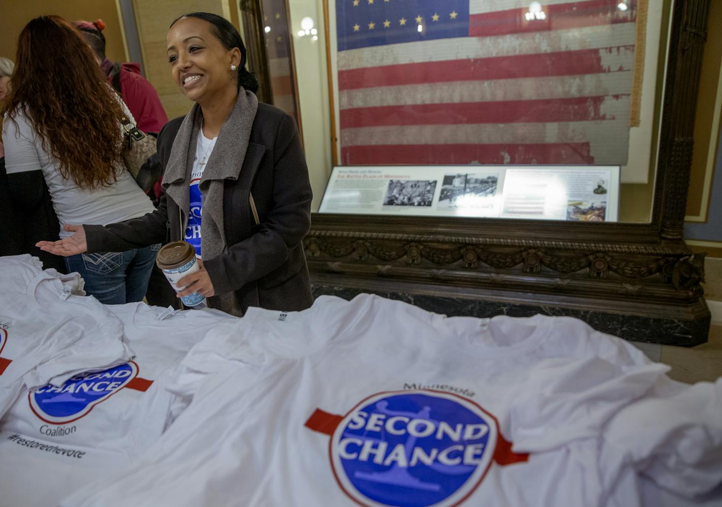 Beth Benti, a Second Chance Coalition board member, handed out t-shirts during the "Second Chance Day on the Hill Rally," Thursday, February 7, 2019 in St. Paul, MN. The rally, held in the State Capitol rotunda, was for those supporters of legislation to restore voting rights to felons who are on probation but not in prison. ] ELIZABETH FLORES &#x2022; liz.flores@startribune.com