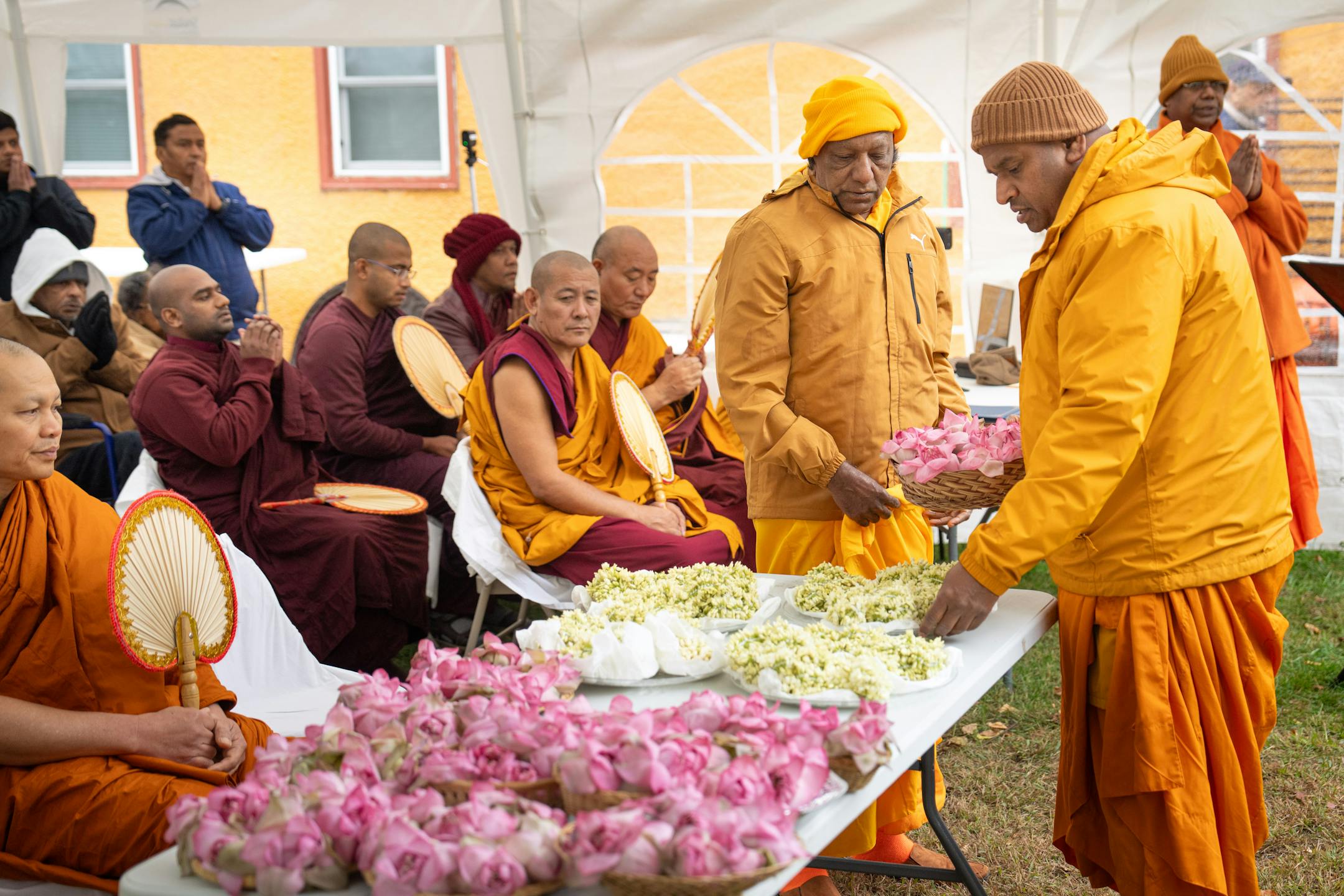 Visiting monk Ullala Chandima Thero, center, and founder of Minnesota Buddhist Vihara, Bhante Seewalie, right, prepared the trays of jasmine and lotus for the ceremony Friday, Oct. 6, 2023 Minneapolis, Minn. This Stupa Unveiling marks a significant milestone in the history of Minnesota Buddhist Vihara and is an occasion of great joy and appreciation. A Stupa is a large white cement dome topped with a brass pinnacle. A sacred stupa is a physical structure in which a relic of the Buddha, enlightened beings, or holy books is enshrined. It creates an opportunity for people to circumambulate and cultivate positive vibration and spiritual development. ] GLEN STUBBE • glen.stubbe@startribune.com