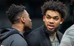 Out with an injury, Minnesota Timberwolves center Karl-Anthony Towns returns to the bench before the start of an NBA basketball game against the Golde