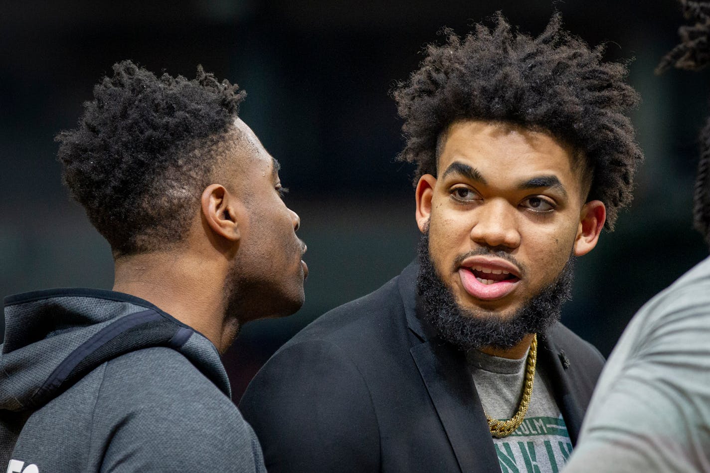 Out with an injury, Minnesota Timberwolves center Karl-Anthony Towns returns to the bench before the start of an NBA basketball game against the Golden State Warriors Thursday, Jan. 2, 2020, in Minneapolis. The Timberwolves won 99-84. (AP Photo/Bruce Kluckhohn)