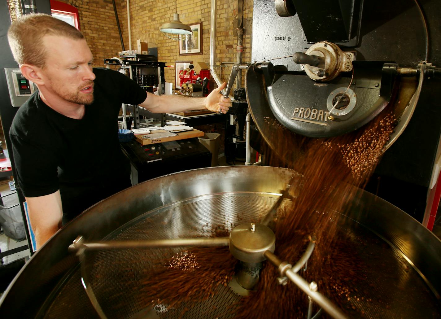 Coffee roaster Eddie Anderson dumps the roasted beans into a cooling mixer at Dogwood Coffee. ] JOELKOYAMA&#x201a;&#xc4;&#xa2;jkoyama@startribune Minneapolis, MN on June 3, 2014. Dogwood Coffee is one of the premier coffee roasting companies in the Twin Cities. This is their NE Minneapolis warehouse where they house their beans and do their roasting.