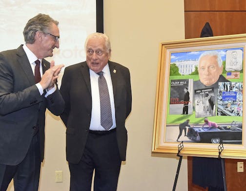 North Dakota Gov. Doug Burgum, left, talks with retired Secret Service agent Clint Hill at the Theodore Roosevelt Rough Rider award at a ceremony on Monday, Nov. 19, 2018, in Washburn, N.D. Gov. Burgum presented Hill with the portrait that will be displayed in the Rough Rider gallery in the state capitol in Bismarck. Hill is the 44th recipient of the state's highest honor. (Tom Stromme /The Bismarck Tribune via AP)