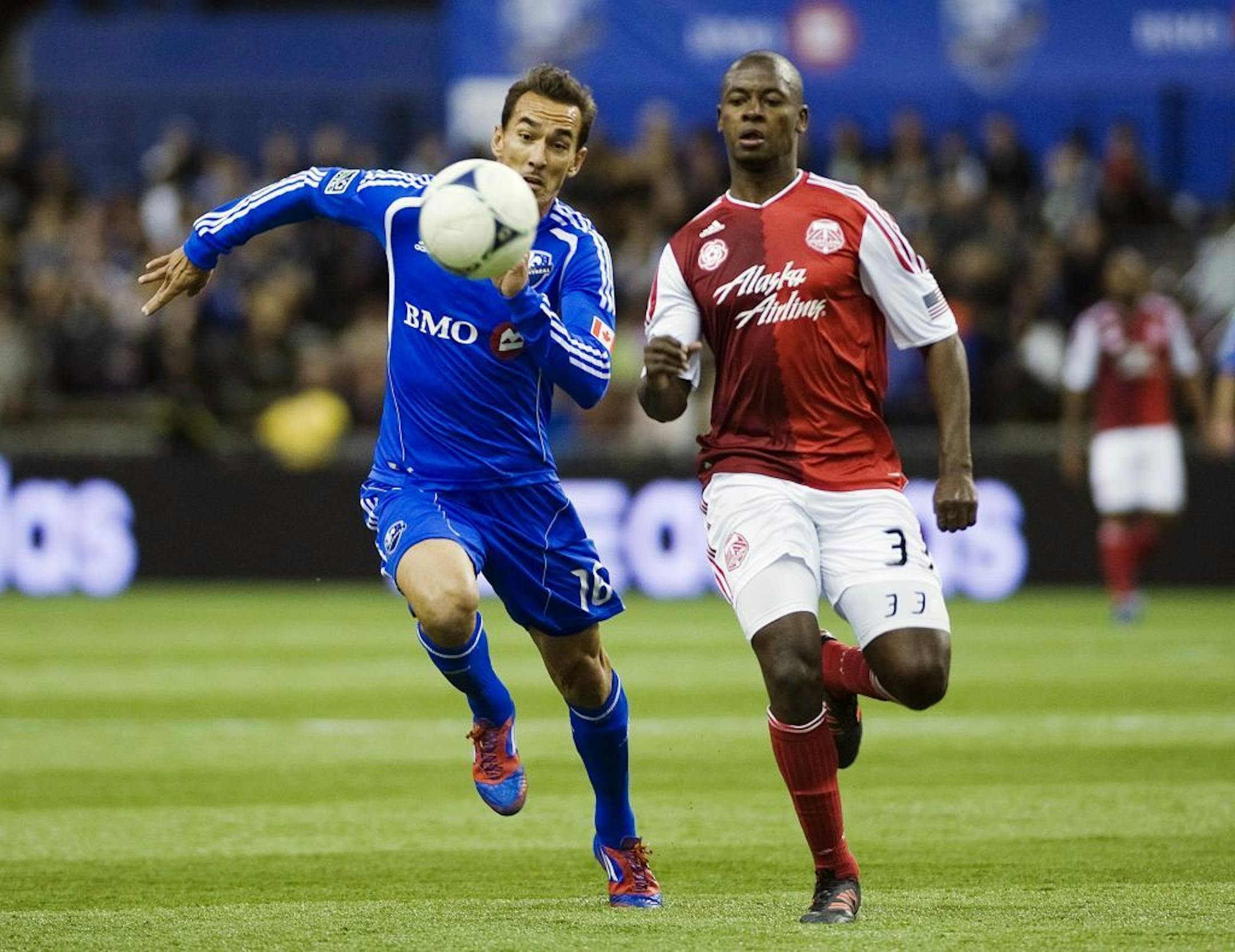 Montreal Impact's Eduardo Sebrango, left, and Portland Timbers' Hanyer Mosquera chase down the ball during the second half of their MLS soccer match in Montreal, Saturday, April 28, 2012.