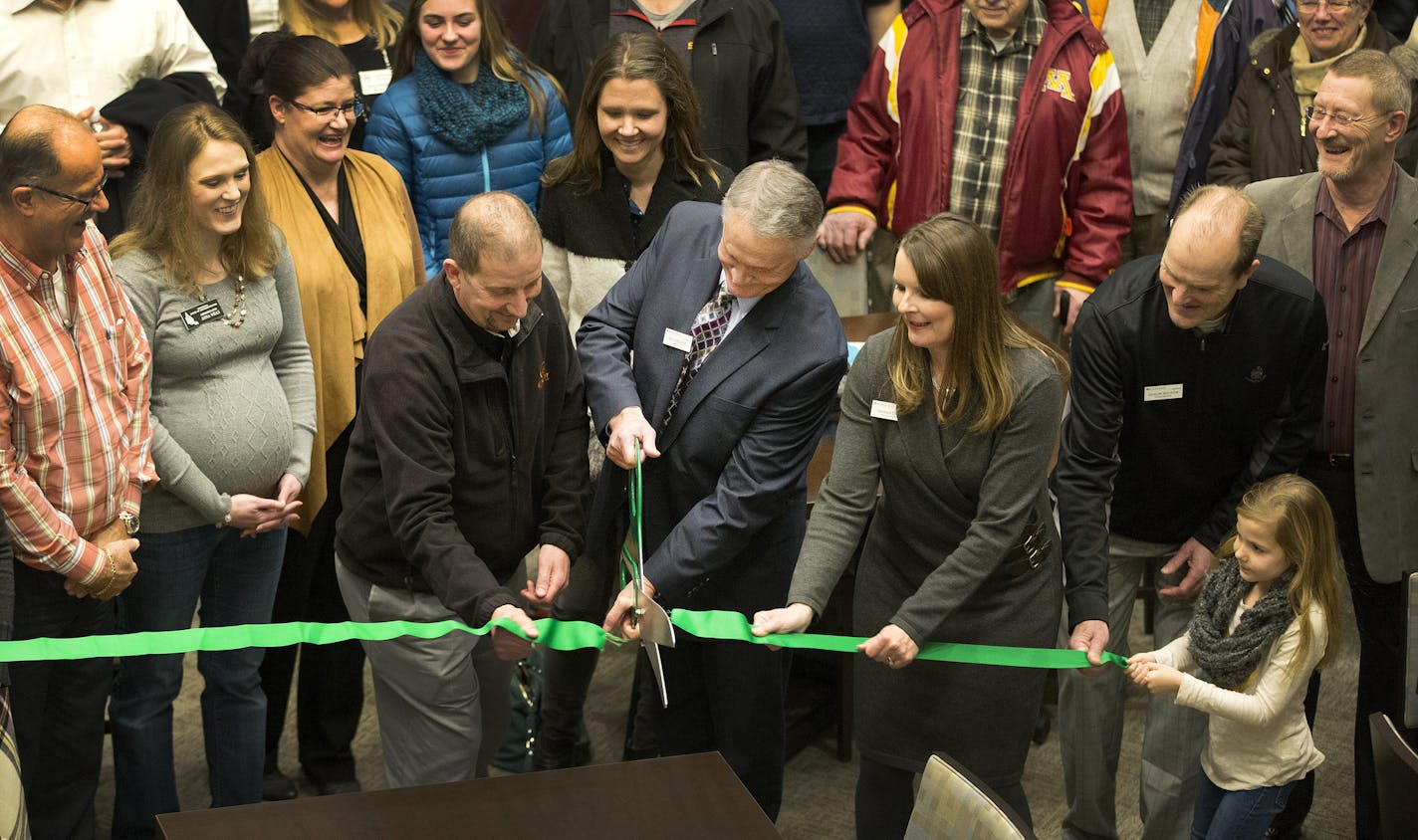 Rosemount Mayor Bill Droste with large scissors during a ribbon cutting ceremony at the Steeple Center expansion project, which connects it to a senior living complex and provides expanded meeting space for seniors and the whole community. ] CARLOS GONZALEZ cgonzalez@startribune.com - February 1, 2016, Rosemount, MN, Rosemount's Steeple Center has finished its expansion project, which connects it to a senior living complex and provides expanded meeting space for seniors and the whole community.