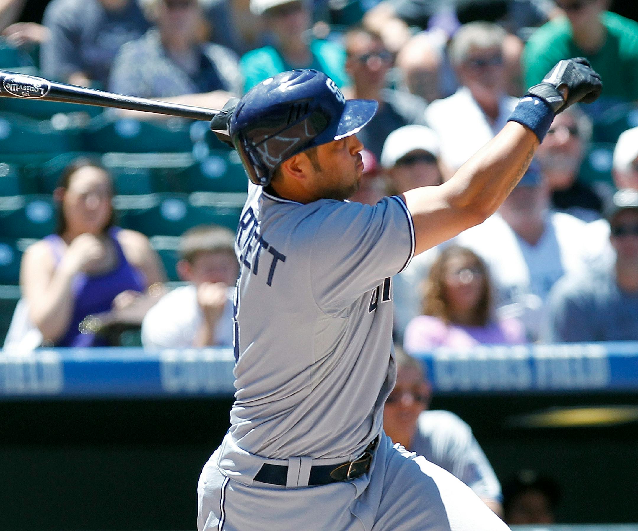 San Diego Padres' Jason Bartlett hits a double in the first inning of a baseball game against the Colorado Rockies at Coors Field in Denver on Wednesday , June 15, 2011. (AP Photo/Ed Andrieski)