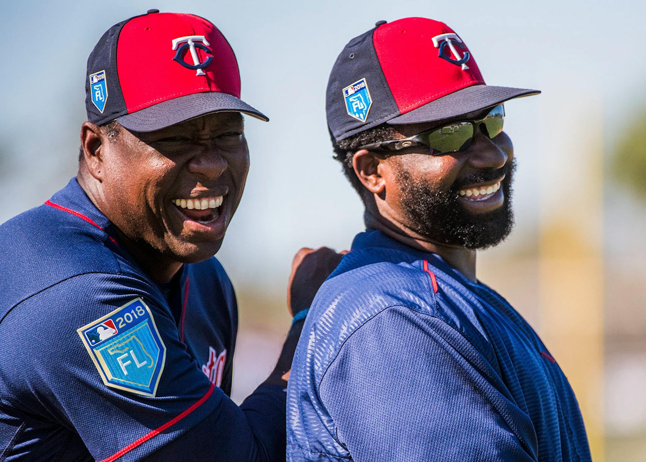 Twins AA pitching coach Ivan Arteaga (91) and Twins AA manager Tommy Watkins (85) hanging out before workouts.