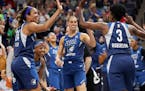 The Minnesota Lynx's Danielle Robinson (3) celebrates her last second basket to end the first quarter with teammate Napheesa Collier (24) and fellow L