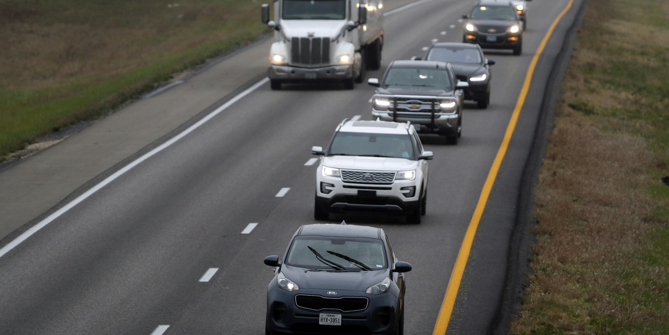 In this photo made Wednesday, Nov. 1, 2017, a driver stays in the passing lane as traffic accumulates behind along I-70 in Montgomery County, Mo. Many states have laws against driving in the left lane except for passing or turning left, which are often ignored by drivers, leading to annoying and dangerous bottlenecks that some experts say are as bad as driving too fast because people get trapped behind and become frustrated prompting some to drive more aggressively. (AP Photo/Jeff Roberson)