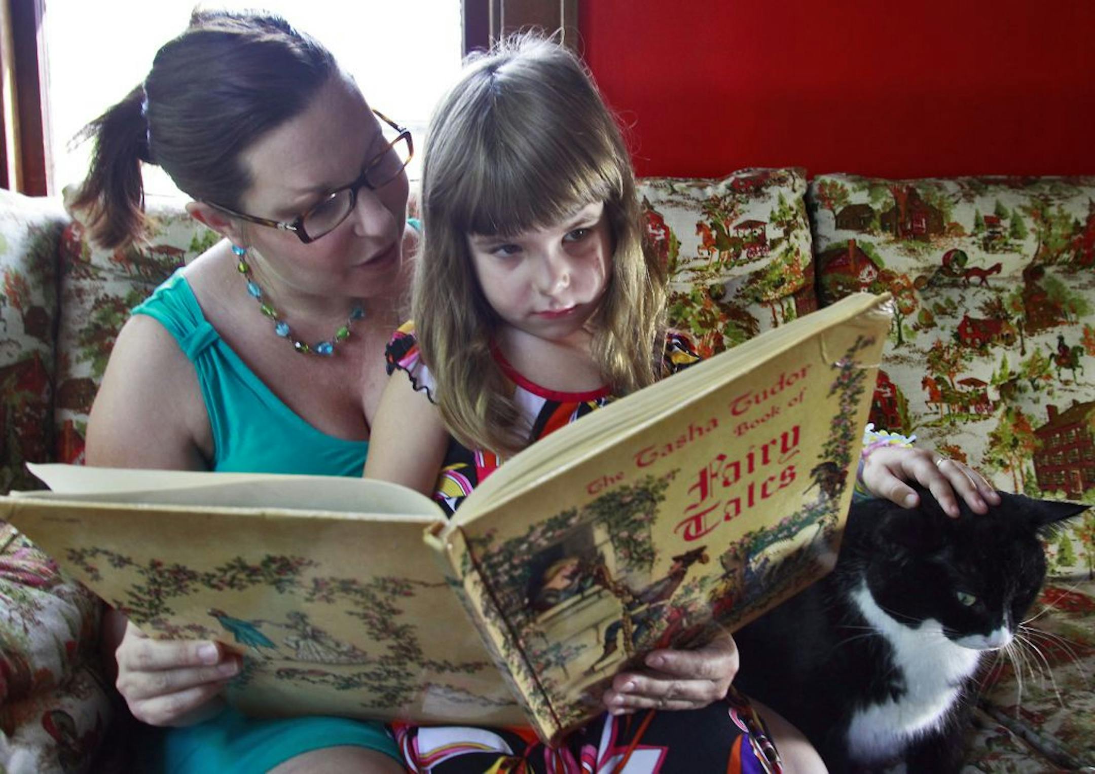 Elle Strike of Minneapolis is preparing her 4-year-old daughter Olive for kindergarten at the end of the month, reading and playing with her during the day at their apartment.
