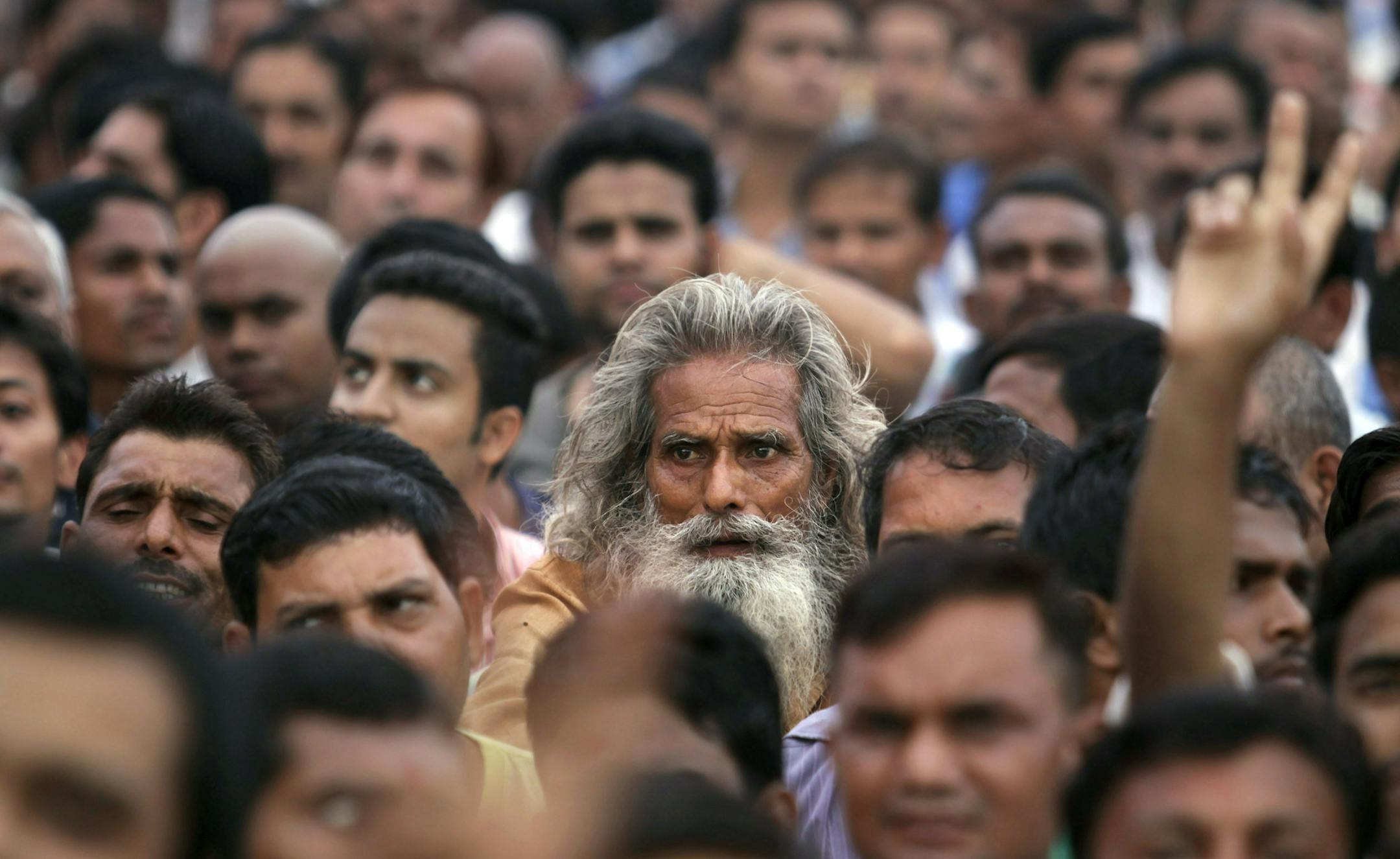 In this Sunday, Sept. 29, 2013 photo, an elderly man listens to a speaker at a political rally in New Delhi. Much of the world is not prepared to support the ballooning population of elderly people, including many of the fastest-aging countries, according to a global study scheduled to be released Tuesday, Oct. 1, by the United Nations and an elder rights group. (AP Photo/Tsering Topgyal)