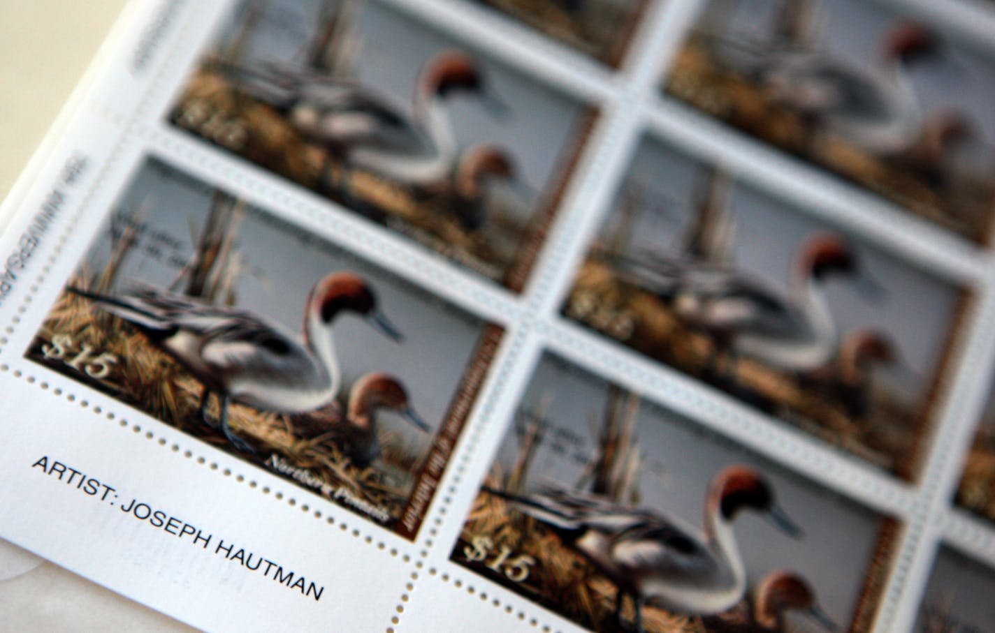 A sheet of stamps with the original painting by Joe Hautman. The adhesive version of these stamps contains a card with an incorrect telephone number.