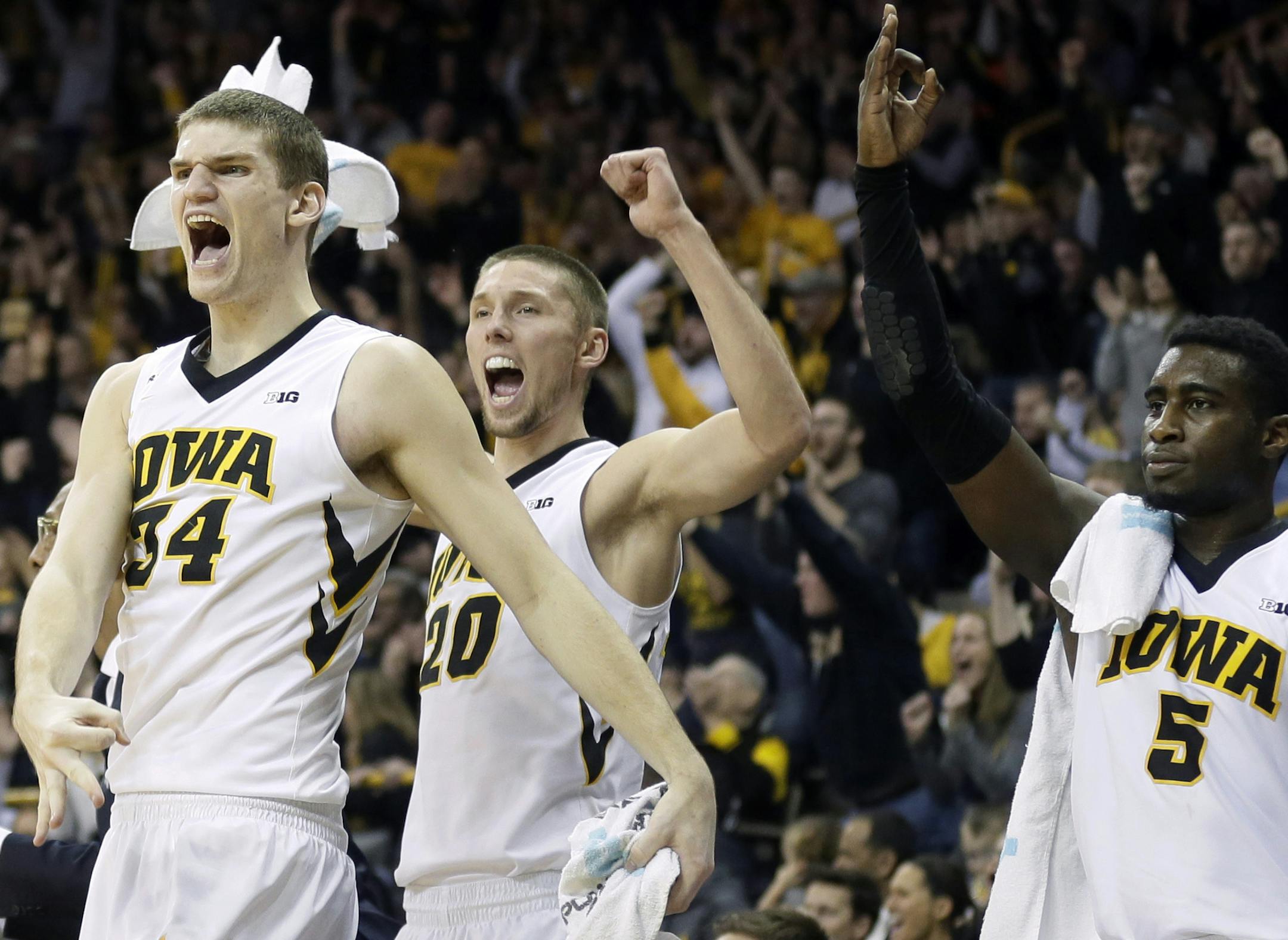 Iowa's Adam Woodbury (34), Jarrod Uthoff (20) and Anthony Clemmons, right, reacted on the bench during the second half of the Hawkeyes' 83-71 victory over Purdue on Sunday.